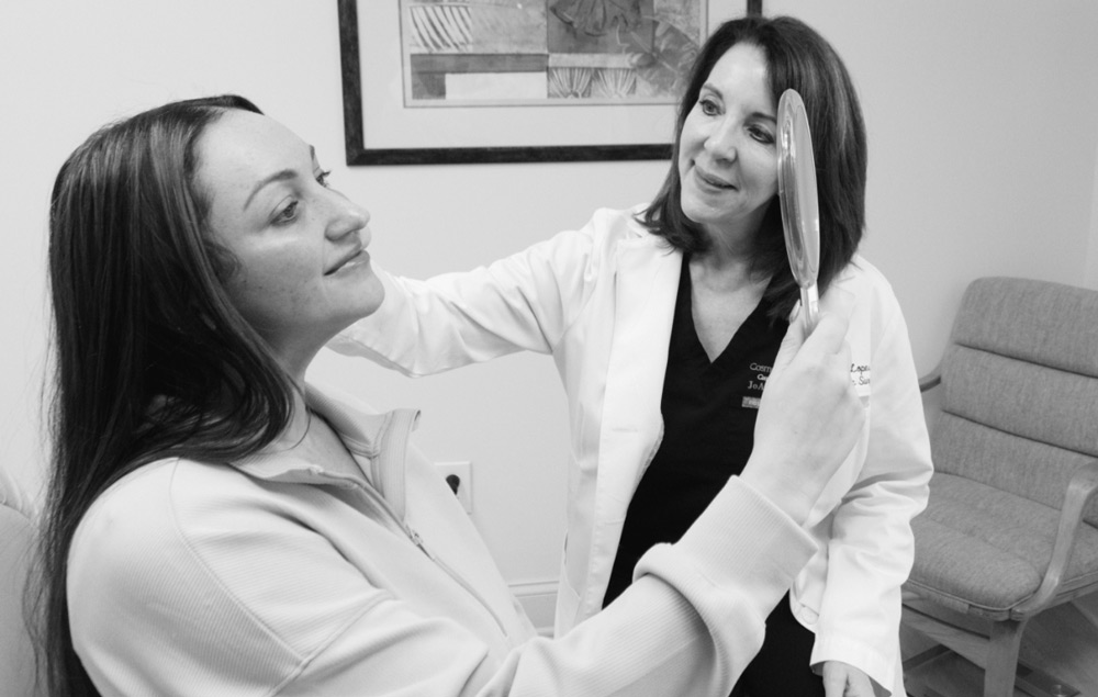 Dr. Lopes examining a patient's face.