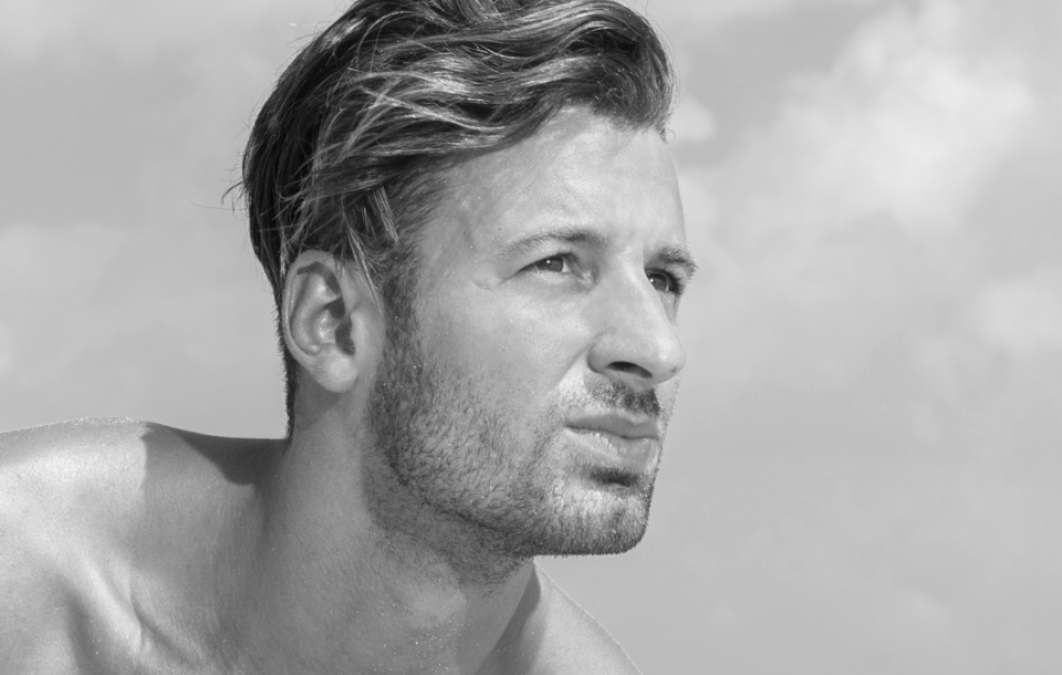 Man gazing forward outdoors, representing natural confidence.