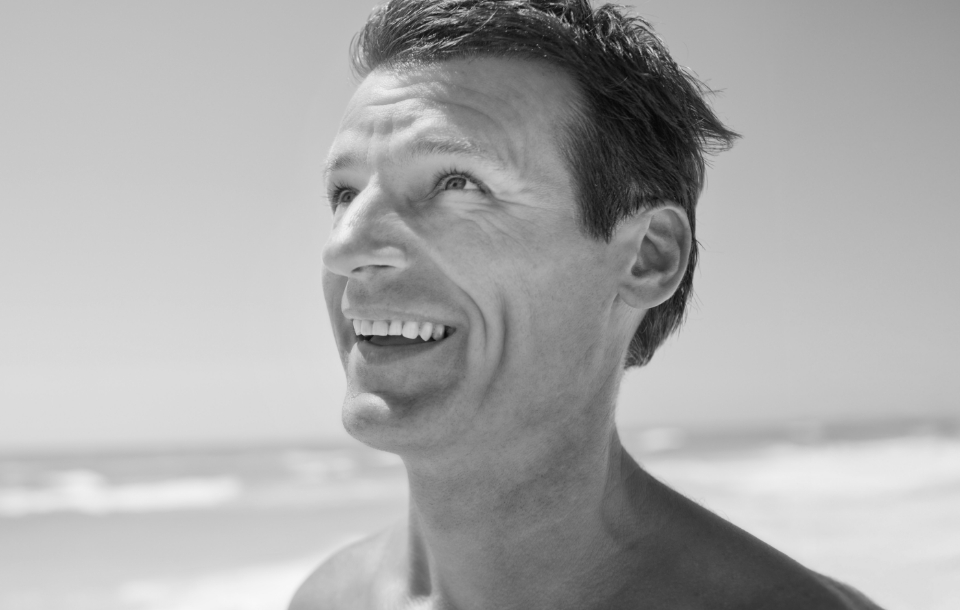 Smiling man at the beach.