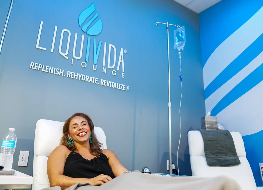 Happy female Liquivida client getting IV drips Renuva Virginia Beach